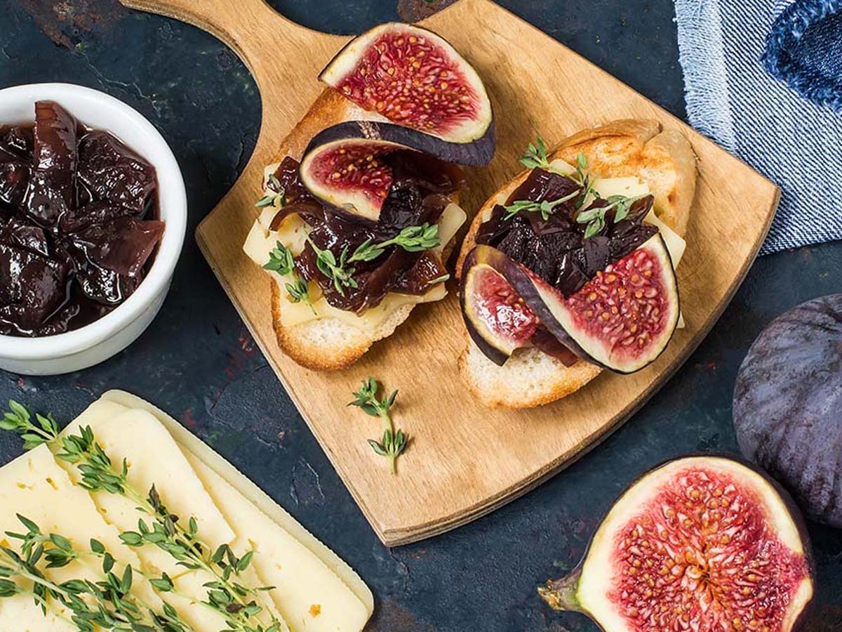A clear jar of rich, thick sweet homemade fig jam preserve showing seeded textures.