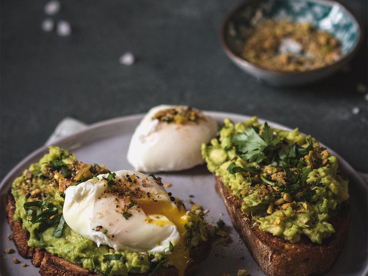 A perfectly poached egg served over a bed of sautéed wild mushrooms and green spinach.